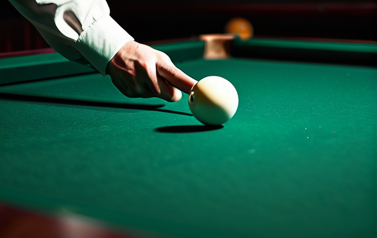 **
A close-up, dynamic shot of a billiards player in mid-stroke. Focus on the cue striking the cue ball with force. Emphasize the motion blur of the cue and ball. The player should be well-dressed in casual but stylish attire. The billiards table should be a rich, dark green. Lighting should be dramatic, highlighting the moment of impact. Add subtle dust particles floating in the air to enhance the sense of motion. Style: Professional sports photography, high resolution, sharp focus on the cue ball impact point, shallow depth of field, safe for work, appropriate content, fully clothed, professional.
**